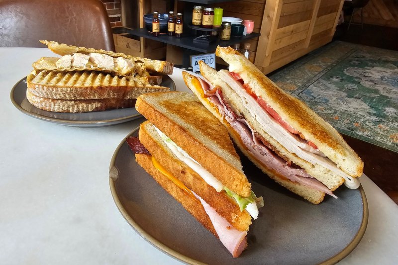 Club sandwich and panini sandwich on plates