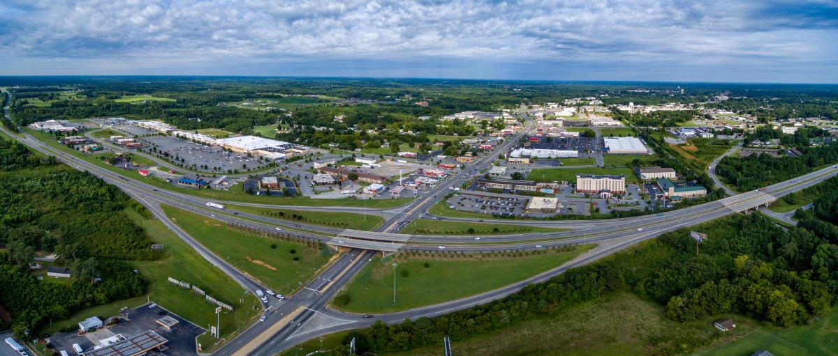 Aerial view of interstate 95 exit 173 showing Roanoke Rapids restaurants, hotels, and shopping right next to the interstate.